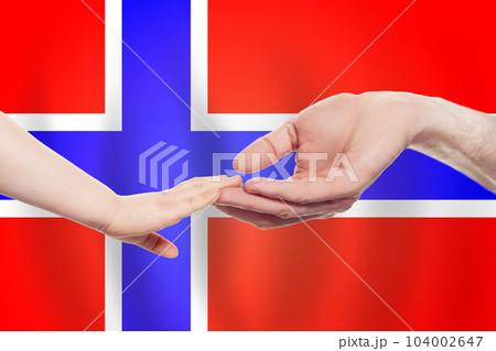 Norwegian baby and parent hands on the background of flag of Norway Help, aid, support 104002647