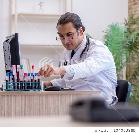 Young male doctor cardiologist working in the clinic Young male doctor cardiologist working in the clinic 104003889