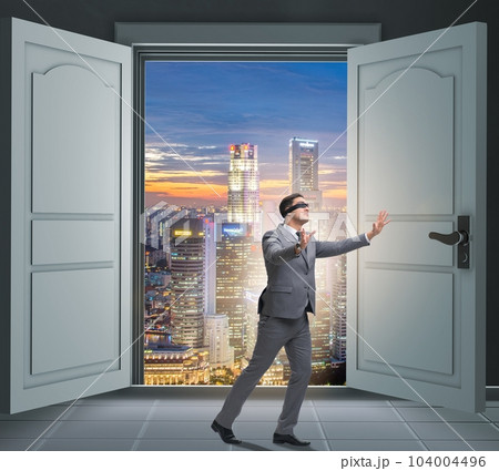 Blindfold businessman in uncertainty concept Blindfold businessman in uncertainty concept 104004496