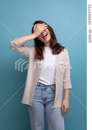 smiling caucasian young brunette woman in shirt and jeans smiling caucasian young brunette woman in shirt and jeans 104004742