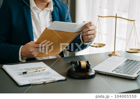 justice and law concept.Male judge in a courtroom on wooden table and Counselor or Male lawyer working in office. . justice and law concept.Male judge in a courtroom on wooden table and Counselor or Male lawyer working in office. . 104005550