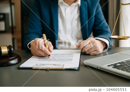 justice and law concept.Male judge in a courtroom on wooden table and Counselor or Male lawyer working in office. . justice and law concept.Male judge in a courtroom on wooden table and Counselor or Male lawyer working in office. . 104005551