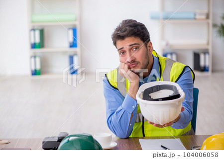 Young male architect working in the office Young male architect working in the office 104006058
