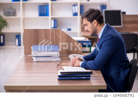 Young male employee working in the office Young male employee working in the office 104008791
