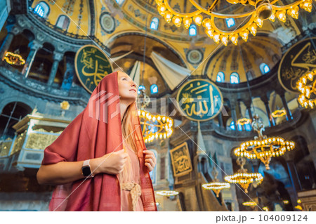 INSCRIPTION - denoting the names of Allah, the Prophet Muhammad, as well as the first 4 caliphs Woman tourist enjoying Hagia Sofia, Ayasofya interior in Istanbul, Turkey, Byzantine architecture, city INSCRIPTION - denoting the names of Allah, the Prophet Muhammad, as well as the first 4 caliphs Woman tourist enjoying Hagia Sofia, Ayasofya interior in Istanbul, Turkey, Byzantine architecture, city 104009124