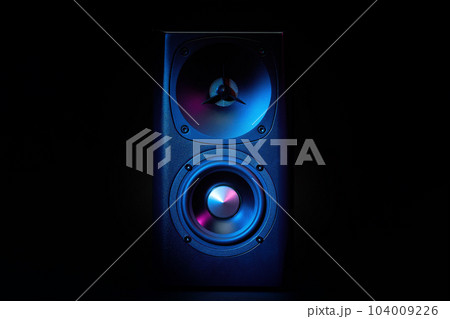 Multimedia acoustic sound speaker with neon lighting. Sound audio system on dark background. 104009226