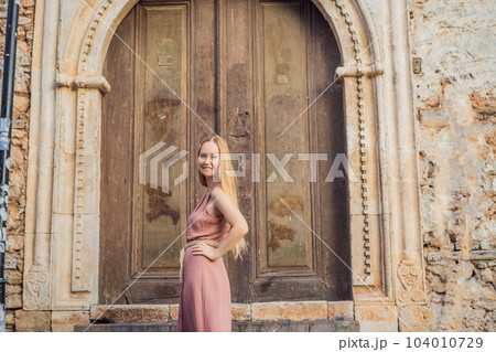 Woman tourist in Old town Kaleici in Antalya. Turkiye. Panoramic view of Antalya Old Town port, Taurus mountains and Mediterrranean Sea, Turkey 104010729