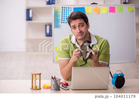 Young male designer in remuneration concept Young male designer in remuneration concept 104011179