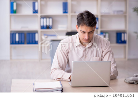 Young male employee working in the office Young male employee working in the office 104011651