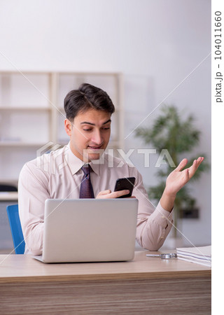Young male employee working in the office 104011660