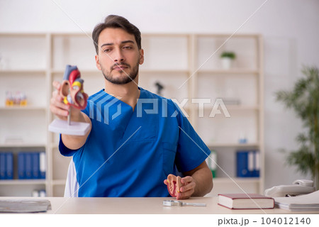 Young male doctor cardiologist working in the clinic 104012140