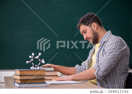 Young male physicist student in the classroom 104012142