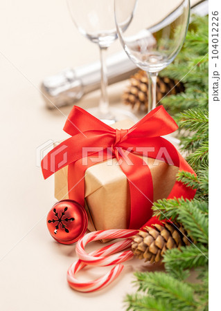Xmas fir tree branch, Christmas gift box, champagne 104012226