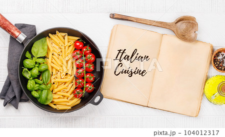A vibrant representation of the Italian flag made with pasta, basil, and tomatoes 104012317