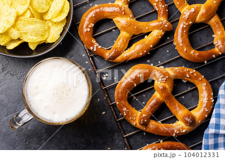 Freshly baked homemade pretzels and draft beer 104012331