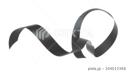Black ribbon long straight fly in air with curve roll shiny. Black ribbon for present gift birthday party to wrap around decorate and make of textile cloth long straight. White background isolated 104013368