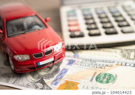 BANGKOK, THAILAND - FEBRUARY 18, 2022, Car on US dollar and calculator; Car loan, Finance, saving money, insurance and leasing time concepts. 104014423