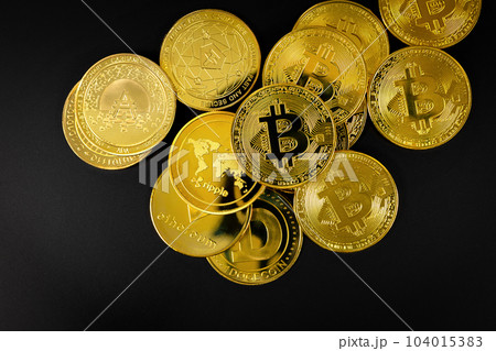 Bitcoin and other Crypto Currency Coins Lying On a Black Background 104015383