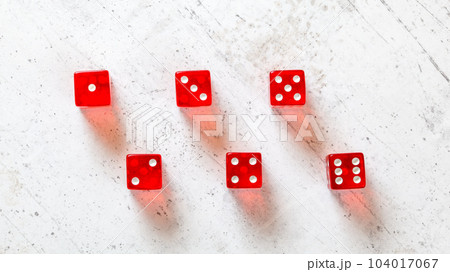 Red translucent craps dices on white board, showing all numbers from 1 to 6 photographed from above Red translucent craps dices on white board, showing all numbers from 1 to 6 photographed from above 104017067