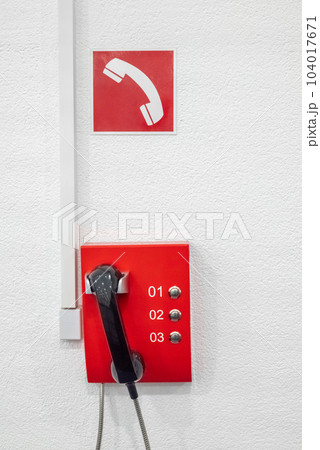 The red emergency telephone in the office building. Telephone system for calling firefighters 104017671