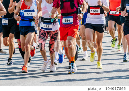 large group runners athletes men and women run city marathon race, numbers on shirts, summer sports games large group runners athletes men and women run city marathon race, numbers on shirts, summer sports games 104017866