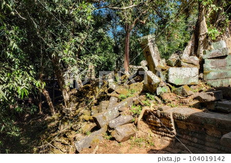 Ancient ruins of the Khmer Empire in a Cambodian forest on a sunny day. Ancient ruins of the Khmer Empire in a Cambodian forest on a sunny day. 104019142