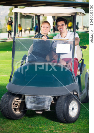 Young man and woman golf players are enjoying game 104019550