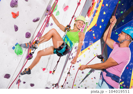 Сouple in climbing outfit training at gym 104019551