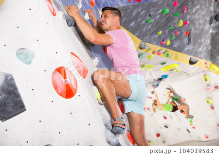 Male on climbing wall without belay Male on climbing wall without belay 104019583