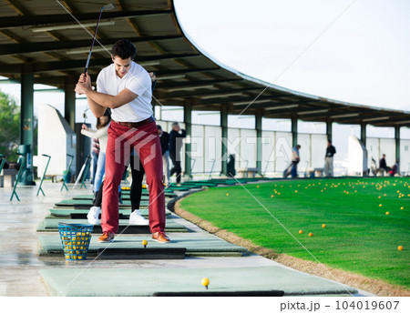 Young golfer is ready for play at golf course 104019607