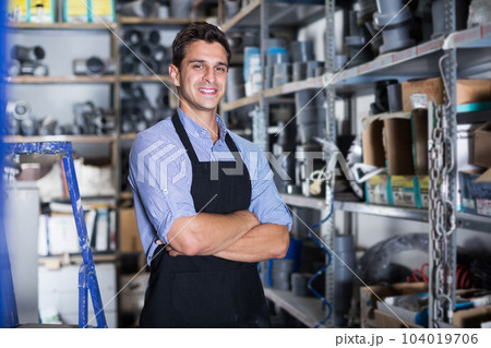 Portrait of smiling male in uniform in workshop 104019706