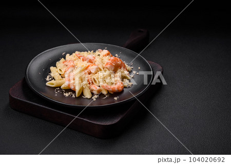 Delicious fresh penna pasta with shrimp, sauce, cheese, salt and spices 104020692