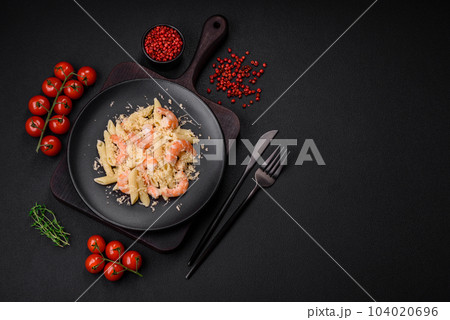 Delicious fresh penna pasta with shrimp, sauce, cheese, salt and spices 104020696