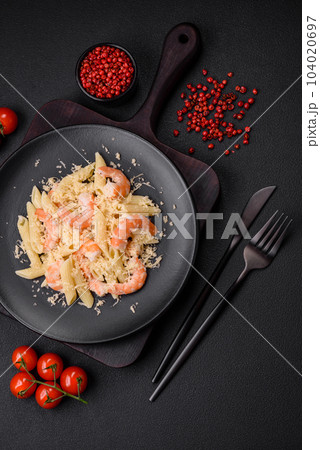 Delicious fresh penna pasta with shrimp, sauce, cheese, salt and spices 104020697