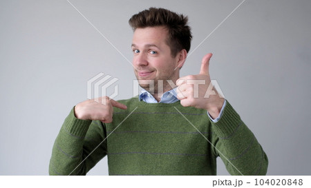 The European young man proudly points at himself, saying I am good with myself 104020848