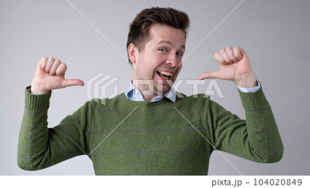 The European young man proudly points at himself, saying I am good with myself 104020849
