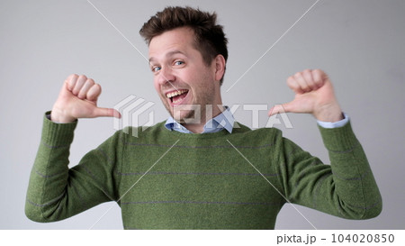 The European young man proudly points at himself, saying I am good with myself 104020850