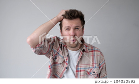 European young person, in bewilderment, grabs their head and asks how could such a thing happen 104020892