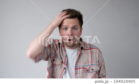 European young person, in bewilderment, grabs their head and asks how could such a thing happen European young person, in bewilderment, grabs their head and asks how could such a thing happen 104020905
