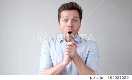 European young man is greatly surprised and opens his mouth in astonishment European young man is greatly surprised and opens his mouth in astonishment 104021020
