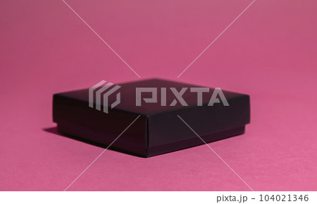 Front view, black gift box on pink background. Front view, black gift box on pink background. 104021346