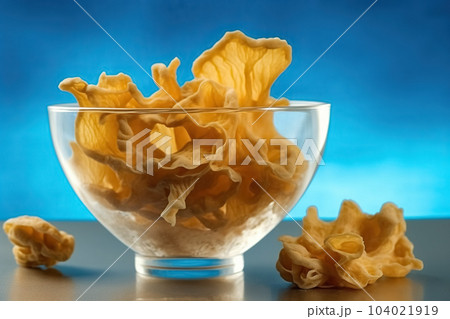A bowl filled with small yellow mushrooms, placed on a table. Generative AI 104021919