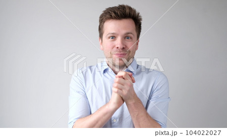 European young man is greatly surprised and opens his mouth in astonishment 104022027