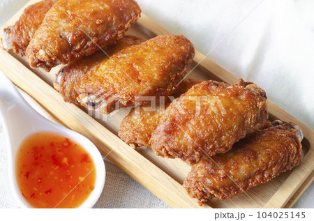 Close up Fried chicken wings and sauce chili Thai street food. Close up Fried chicken wings and sauce chili Thai street food. 104025145