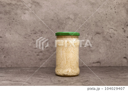 Preserved Celery Root Salad In Glass Jar With Screw Metal Cap On Shelf. Apium Graveolens, Shredded And Pickled Celery Crops, Tuber. Culinary. Vitamins C, K, A, E, PP, B. Copy Space, Horizontal Plane Preserved Celery Root Salad In Glass Jar With Screw Metal Cap On Shelf. Apium Graveolens, Shredded And Pickled Celery Crops, Tuber. Culinary. Vitamins C, K, A, E, PP, B. Copy Space, Horizontal Plane 104029407