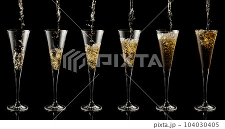 Pouring sparkling wine into a glass on a black background. 104030405