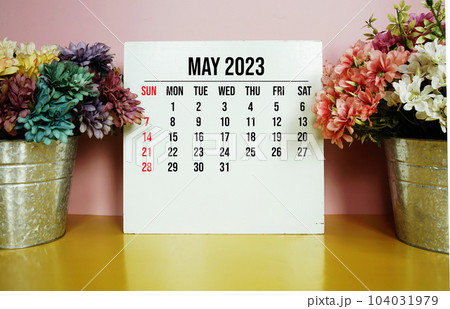 May 2023 monthly calendar on easel stand on wooden background 104031979