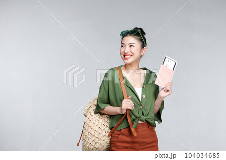 Beautiful travel woman with passport isolated on white background Beautiful travel woman with passport isolated on white background 104034685