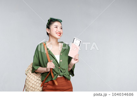 Excited happy tourist woman with passport, ticket isolated on white background Excited happy tourist woman with passport, ticket isolated on white background 104034686
