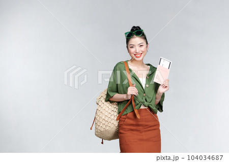 Portrait of a happy smiling young girl holding passport and travelling tickets Portrait of a happy smiling young girl holding passport and travelling tickets 104034687